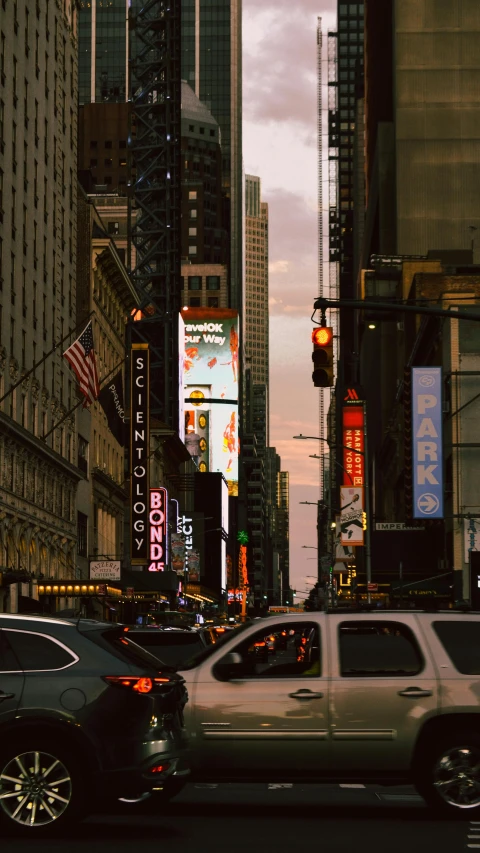 a city street filled with traffic at dusk