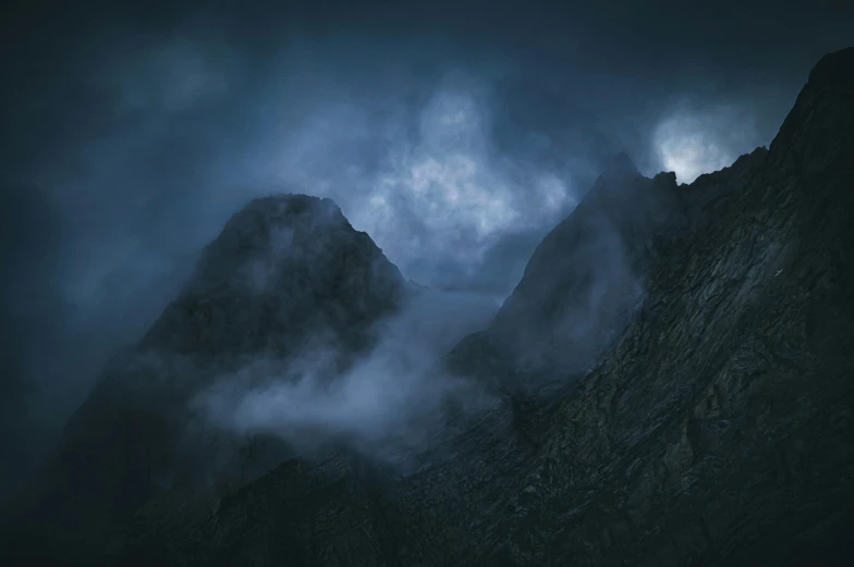 mountains with fog and light in the sky