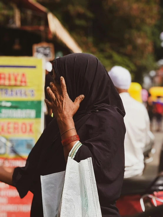 an elderly woman with a handbag talking on her phone