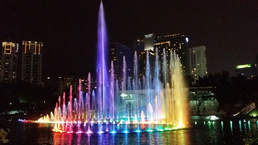 a colorful fountain in the middle of a body of water, interactive art, kuala lumpur, los angeles 2 0 1 5, blog-photo, disney colors