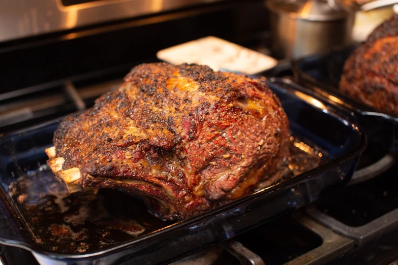 a roasting pan filled with meat sitting on top of a stove, by Matt Cavotta, side profile shot, big moe, recipe, holiday season