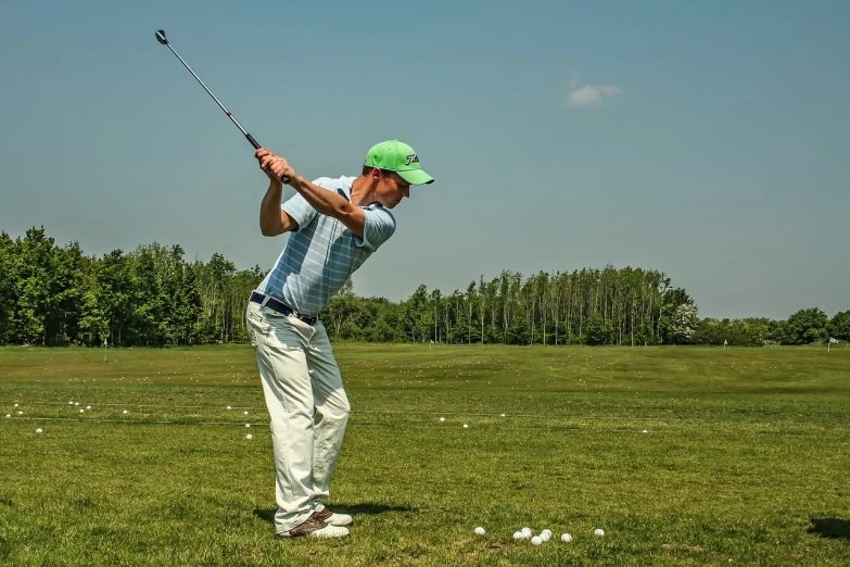 a man in a green hat swinging a golf club, a portrait, by Jan Rustem, pixabay, beijing, training, a wide shot, bendover posture