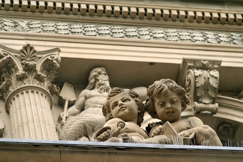 a couple of statues sitting on top of a building, inspired by Sir Jacob Epstein, flickr, art nouveau, putti, three heads, neptune, intricate detail and composition