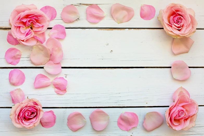 a wooden table topped with pink roses and petals, trending on pixabay, banner, framing, pose 1 of 1 6, deck