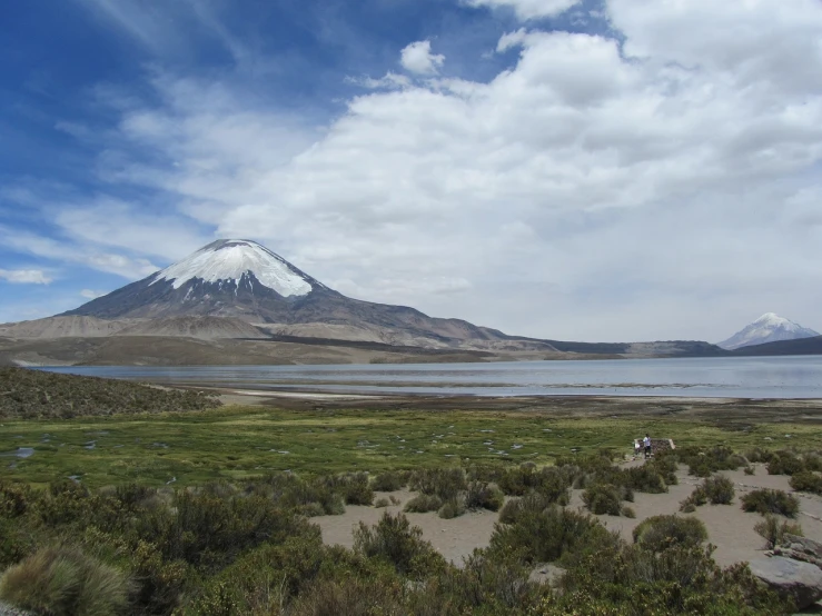 a mountain in the distance with a lake in the foreground, flickr, hurufiyya, in chuquicamata, volcano in the background, doran, very very very very beautiful