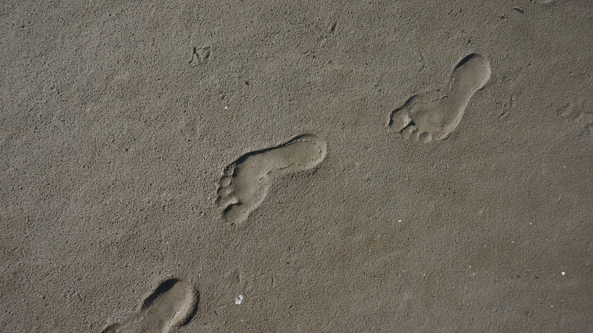 a couple of footprints that are in the sand, graffiti, taken with a pentax1000, outdoor photo, high - detail, pregnancy