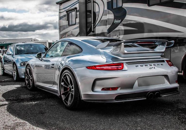 a group of cars parked next to each other, by Maurice Esteve, pexels contest winner, photorealism, porsche rsr, sleek silver armor, mobile wallpaper, full view of a sport car