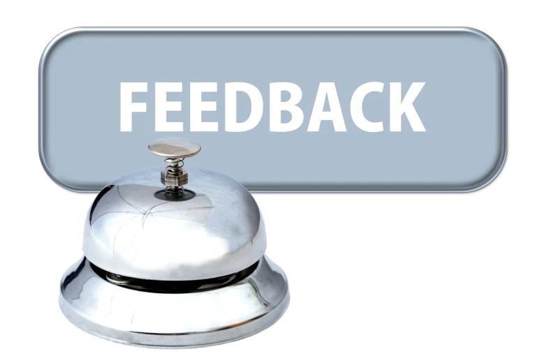 a bell sitting in front of a sign that says feedback, silverplate, on a white background, rating: general, no words