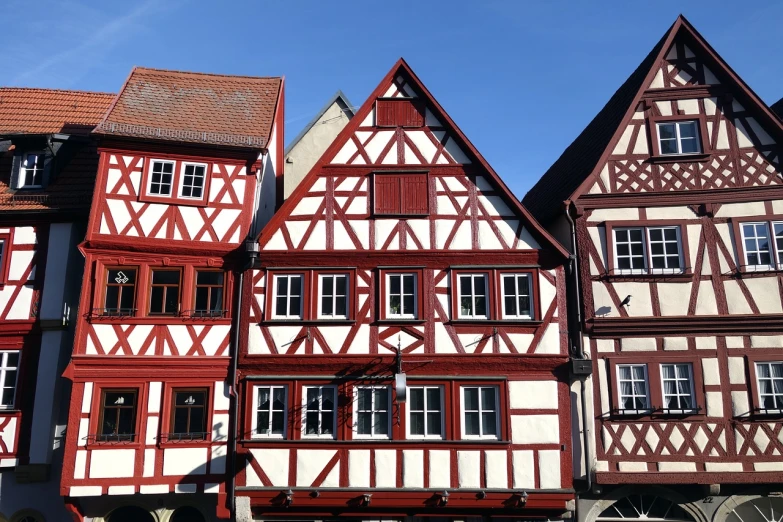 a couple of buildings that are next to each other, by Robert Zünd, renaissance, red white and black color scheme, timbered house with bricks, closeup photo, in a medieval city