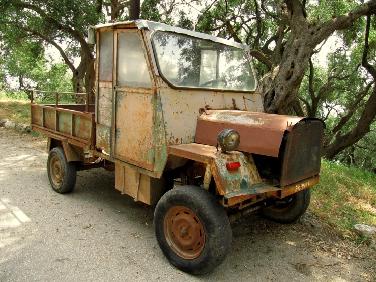 an old rusted truck is parked on the side of the road, flickr, mingei, bangalore, prototype car, three - quarter view, prototype