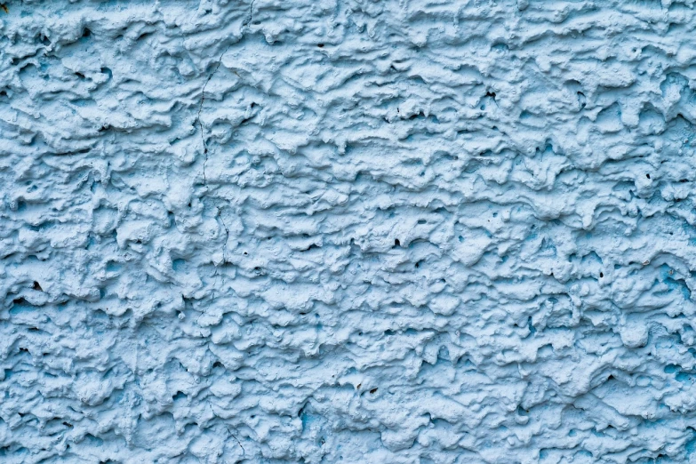 a close up of a blue painted wall, inspired by William Congdon, shutterstock, stylized stone cladding texture, white foam, modern high sharpness photo