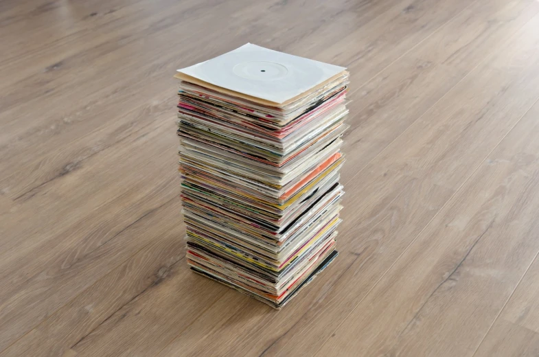 a stack of magazines sitting on top of a wooden floor, by Ottó Baditz, dada, vinyl records, 1 0 0 0 mm, hasselblatt, 2 0 1 1
