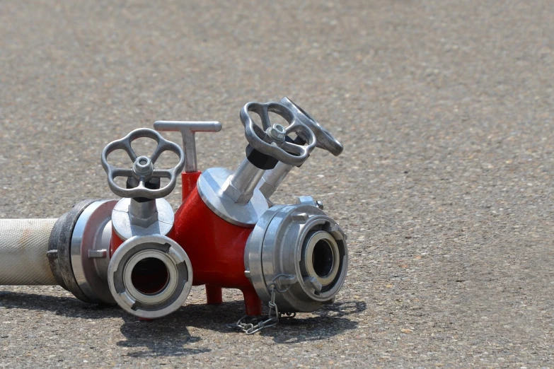 a close up of a fire hydrant on the ground, a photo, articulated joints, twins, abcdefghijklmnopqrstuvwxyz, stainless steal