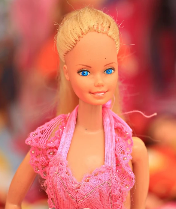 a close up of a barbie doll wearing a pink dress, by Gwen Barnard, flickr, with a happy expression, compressed jpeg, istockphoto, disturbing