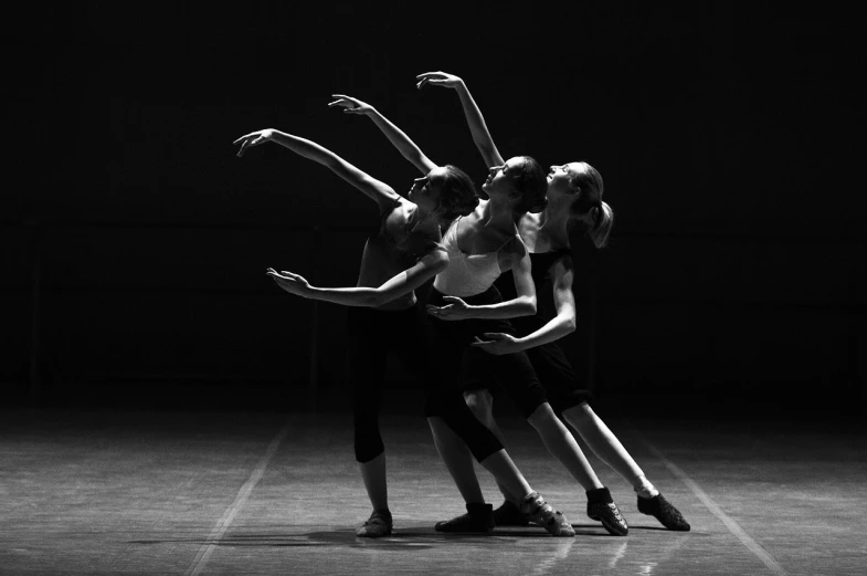 a black and white photo of a group of dancers, by Zoltán Joó, shutterstock, girl graceful, trio, technical, concert