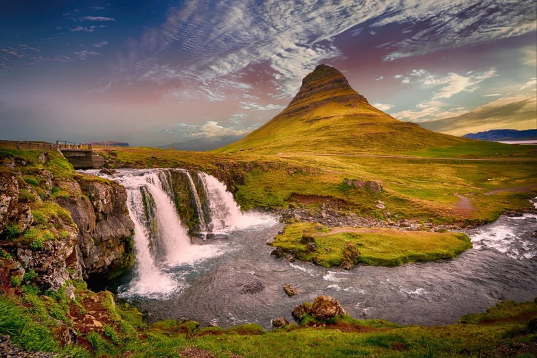 a waterfall with a mountain in the background, shutterstock, iceland hills in the background, a paradise like a fairyland, post-processed, the shire