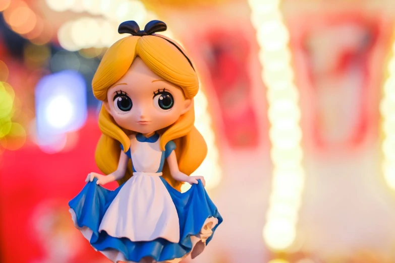 a close up of a doll on a table, inspired by Alice Prin, shutterstock, disneyland background, as a funko pop!, low angle photo, blonde - haired princess