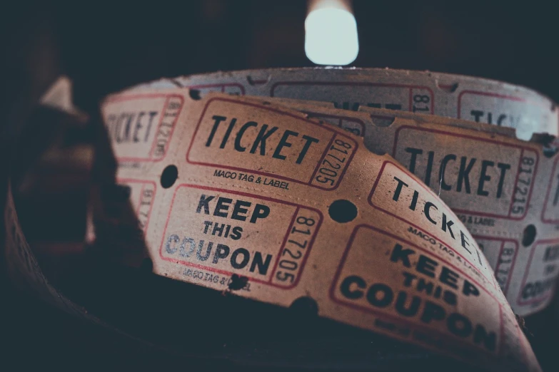 a pair of tickets sitting on top of a table, pexels contest winner, 7 0 s photo, thumbnail, all rights reserved, crypto