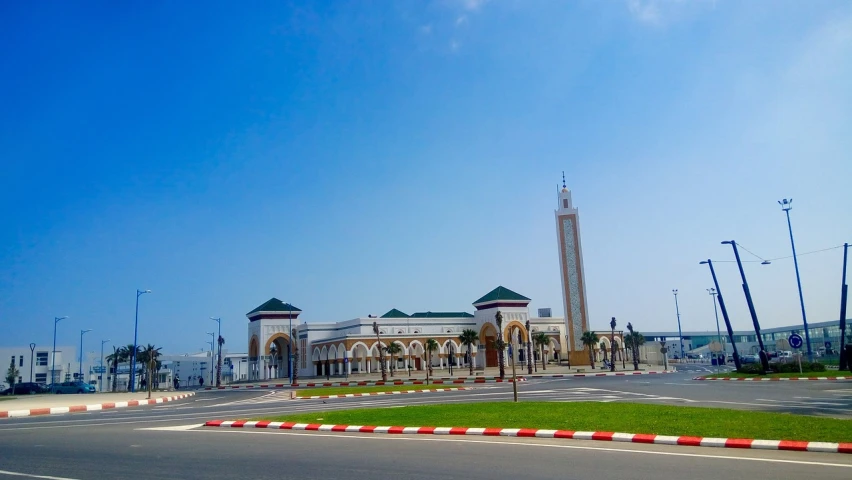 a large building sitting on the side of a road, arabesque, moroccan city, terminal, beautiful place, monument