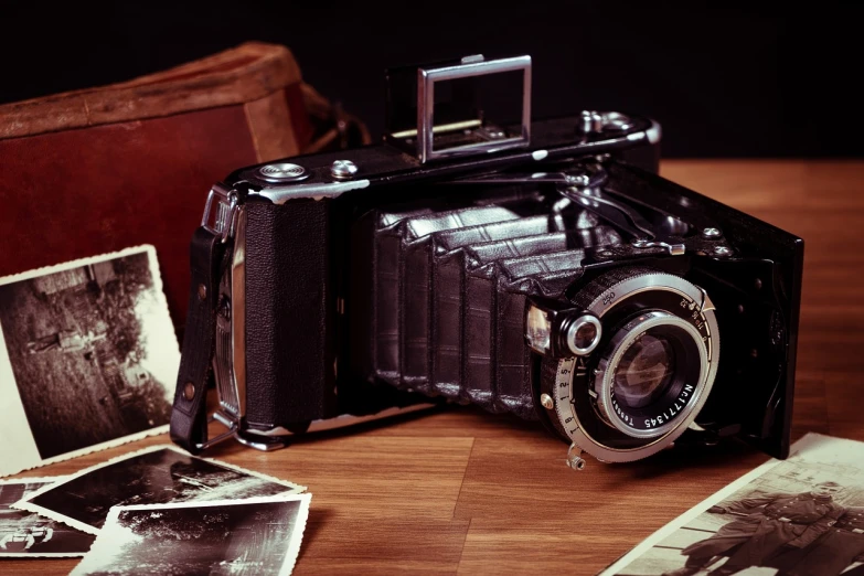 an old camera sitting on top of a wooden table, a picture, by Dariusz Zawadzki, packshot, 4 k photo, old timey, auto graflex