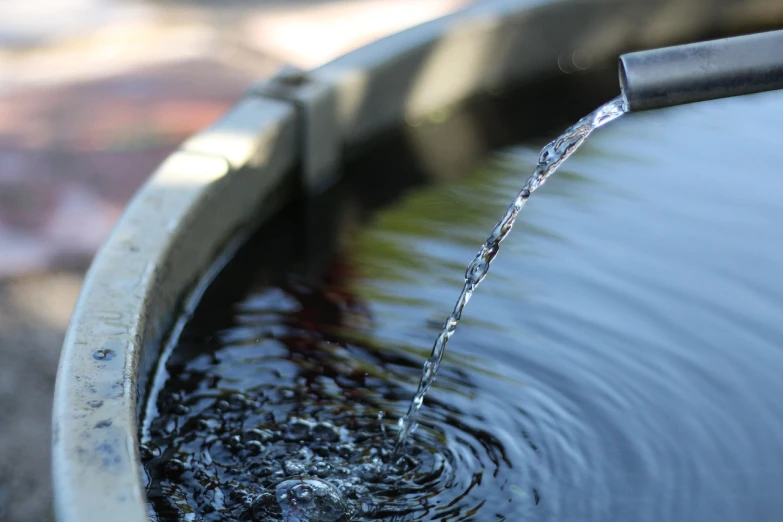 a close up of a water fountain with a hose, pexels, stock photo, low camera angle at water level, detailed illustration, watertank