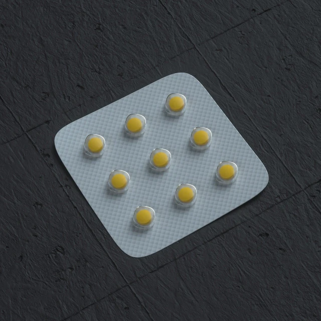 a pack of pills sitting on top of a tiled floor, silicone patch design, 3 d models, yellow artificial lighting, high resolution product photo