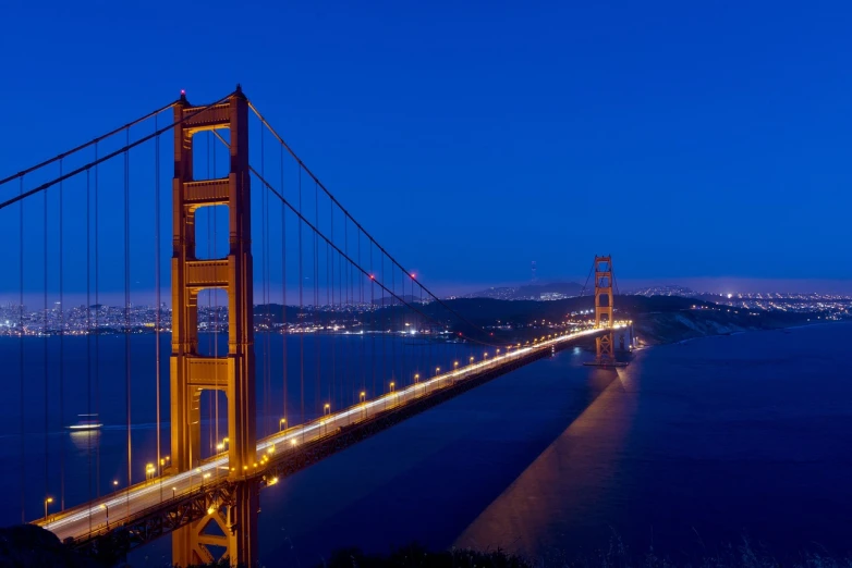 a view of the golden gate bridge at night, a picture, flickr, hurufiyya, glowing blue by greg rutkowski, elegant bridges between towers, istockphoto, high bridges