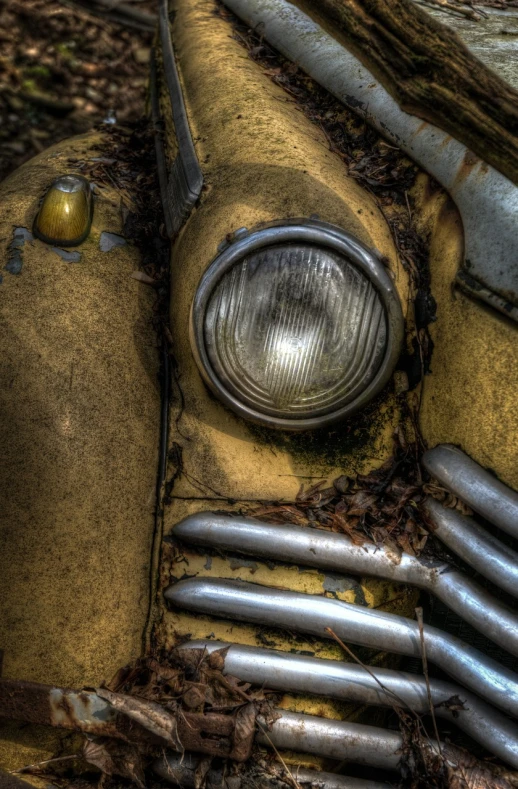 a close up of an old car in the woods, a macro photograph, by Thomas Häfner, flickr, glowing yellow face, hdr!, face!!!! close - up, crying engine