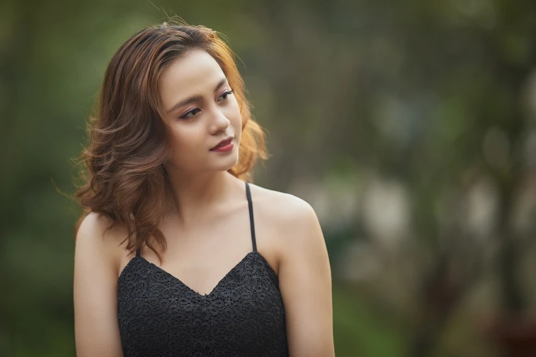 a woman in a black dress posing for a picture, by Ni Yuanlu, strong bokeh, a cute and beautiful young woman, bare shoulders, beautiful young himalayan woman