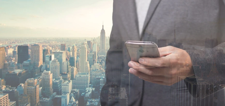 a man in a suit holding a cell phone, a picture, by Barron Storey, pexels, digital art, new york city background, istockphoto, composite, hazy