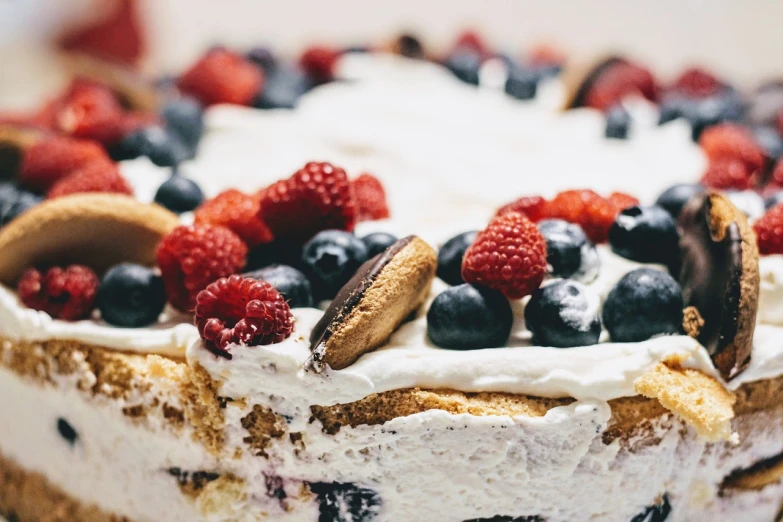 a close up of a cake with berries on top, by Matija Jama, pexels, figuration libre, whipped cream, waist high, 🎀 🗡 🍓 🧚, navy