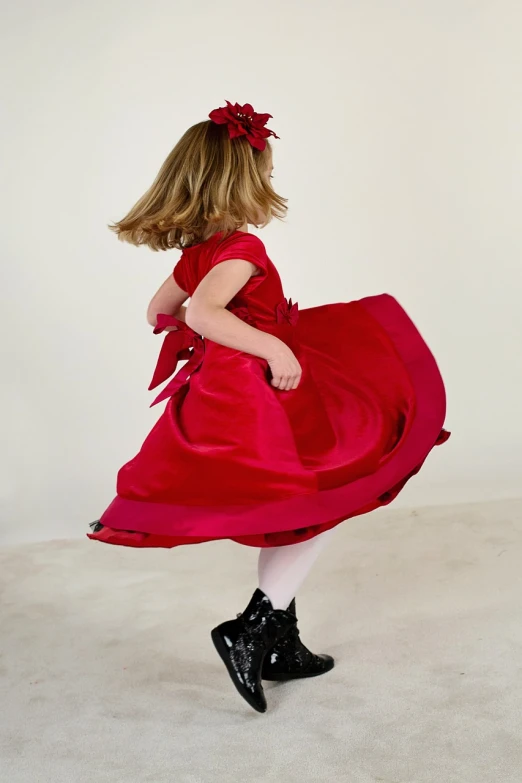 a little girl in a red dress and black boots, inspired by Edwin Austin Abbey, arabesque, backshot, swirling red-colored silk fabric, thick bow, high res photograph