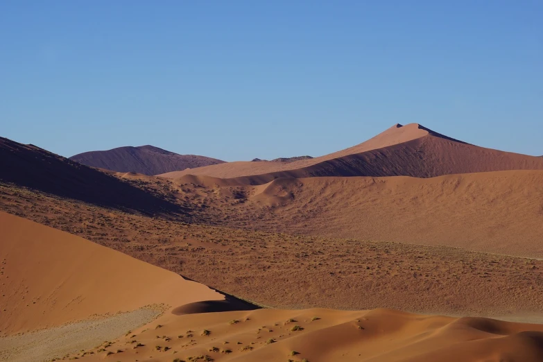 a person riding a horse in the desert, a picture, by Dietmar Damerau, shutterstock, fairy circles, seen from a distance, dune, november