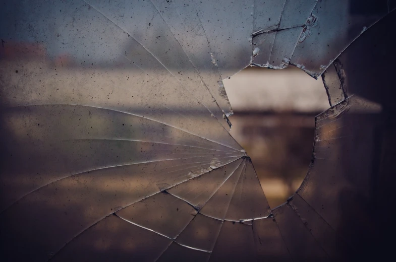 a broken window with a hole in it, pexels, bokeh. debadged, ivan shishk, iphone background, fracture