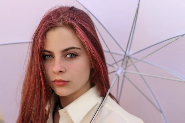 a woman with red hair holding an umbrella, a portrait, by Juan O'Gorman, pixabay contest winner, portrait of white teenage girl, split hair dye, barbara hammer 4 k, close-up professional portrait