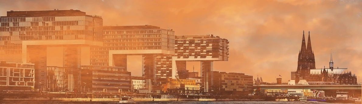 a large body of water surrounded by tall buildings, a matte painting, inspired by Victor Enrich, pixabay contest winner, hypermodernism, hannover, bathed in golden light, all buildings on bridge, sunfaded