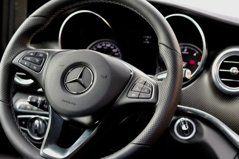 a close up of a steering wheel in a car, a picture, by Matthias Stom, mercedez benz, high detail photo, interior of a small, rectangular