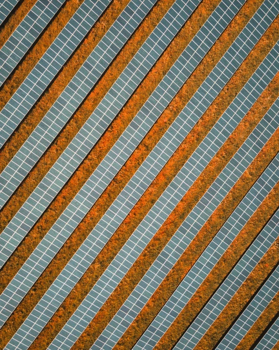 a close up of a metal surface with lines, by Richard Carline, unsplash contest winner, solar field plains, orange and green power, australian, drone photography