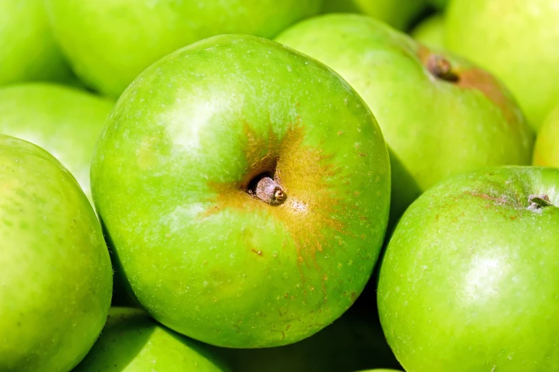 a pile of green apples sitting on top of each other, zoomed in, high quality product image”