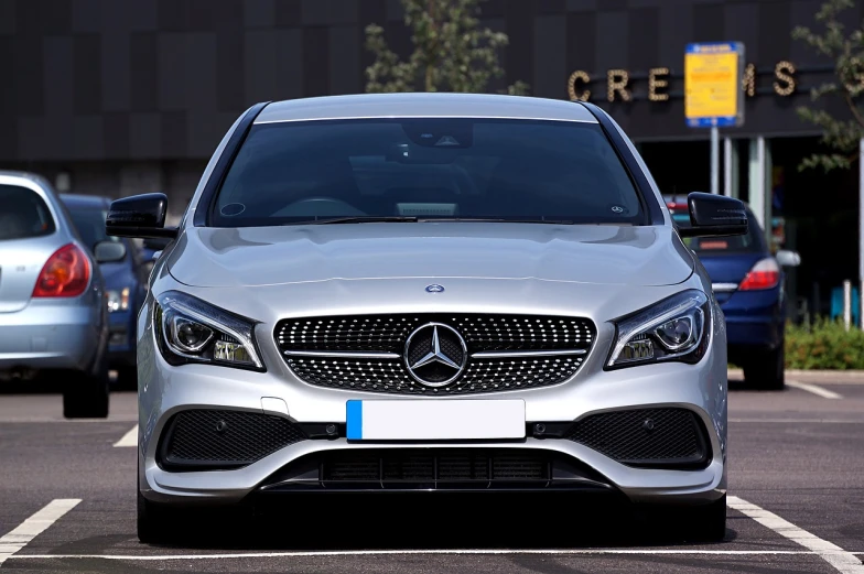 a silver car is parked in a parking lot, a picture, pixabay, mercedez benz, front face asymmetrical, carbon, f 3 2