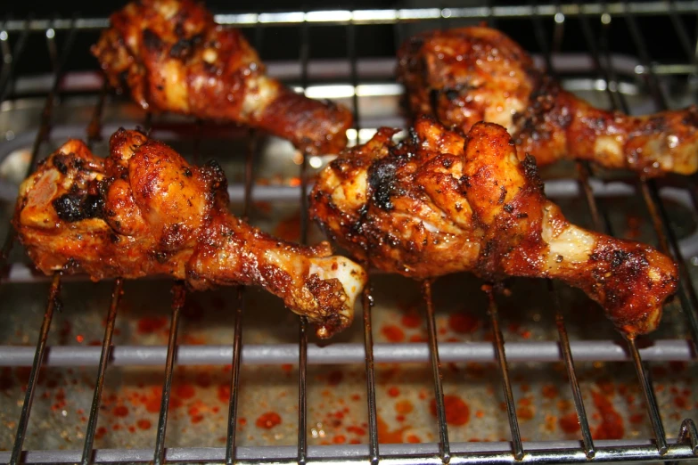 the chicken is cooking on the grill in the oven, by Ella Guru, hurufiyya, bone wings, jamaican, image, 3 4 5 3 1