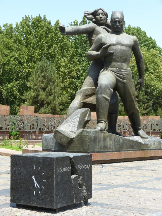 a statue of a man hitting a woman with a baseball bat, a statue, inspired by György Rózsahegyi, flickr, socialist realism, samarkand, right side composition, sunken square, hammer and sickle