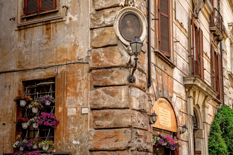 a clock mounted to the side of a building, a portrait, by Alessandro Allori, shutterstock, renaissance, old signs, lamps and flowers, ancient roman style, sanjulian. detailed texture