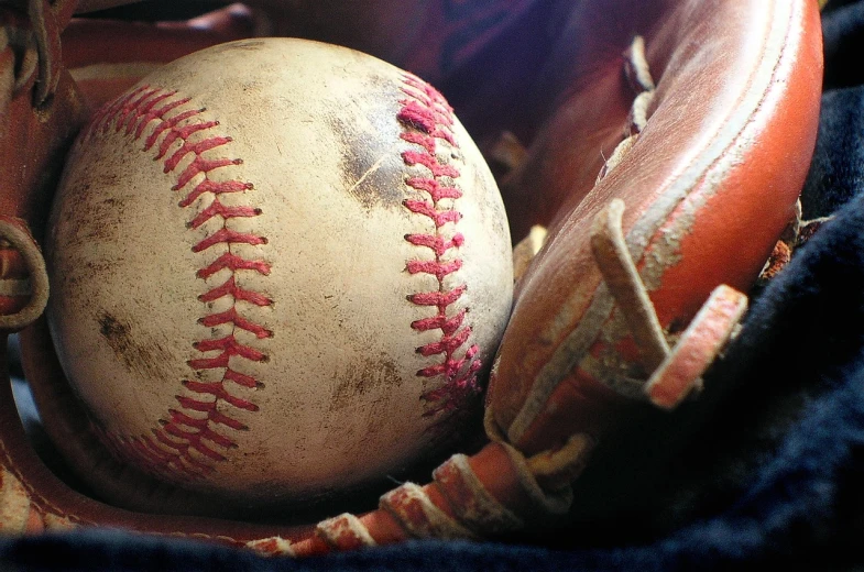 a close up of a baseball in a catchers mitt, a picture, flickr, renaissance, relaxing, grain”