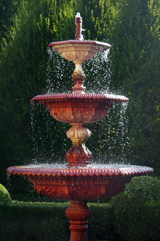 a fountain with a bird sitting on top of it, inspired by Cherryl Fountain, arabesque, red water, stacked, mid morning lighting, victoriana