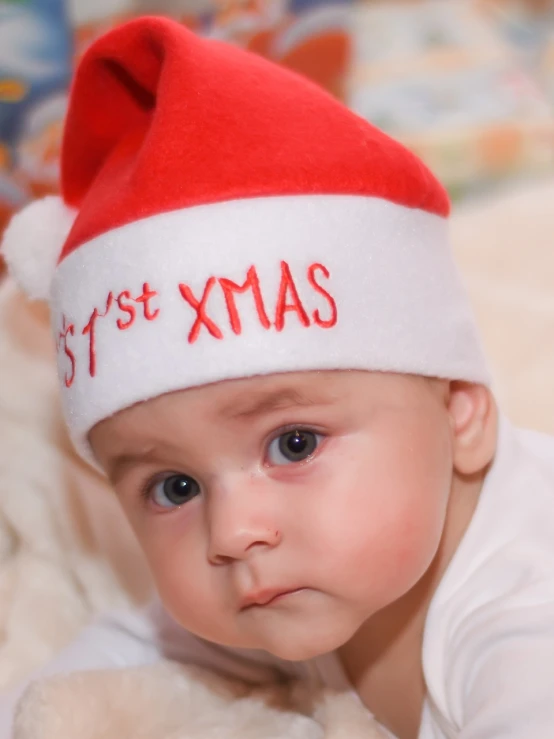 a close up of a baby wearing a santa hat, dada, istockphoto, orthodox, image, proud serious expression