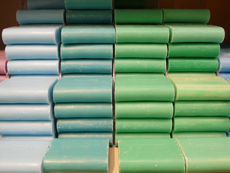 a stack of green and blue boxes stacked on top of each other, a pastel, inspired by Raoul De Keyser, flickr, color field, roofing tiles texture, stacking supermarket shelves, soft coloured gel lighting, ((greenish blue tones))