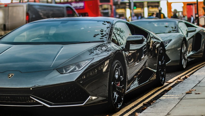 a black sports car parked next to a red double decker bus, pexels contest winner, bold lamborghini style, crypto, black and silver, twins