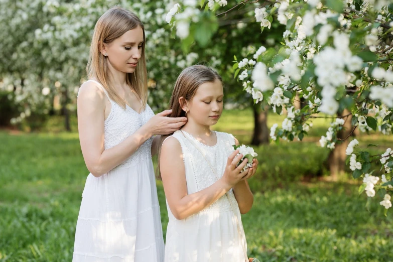 a couple of young girls standing next to each other, a picture, inspired by William-Adolphe Bouguereau, shutterstock, naive art, apple blossoms, paradise garden massage, family photo, polish