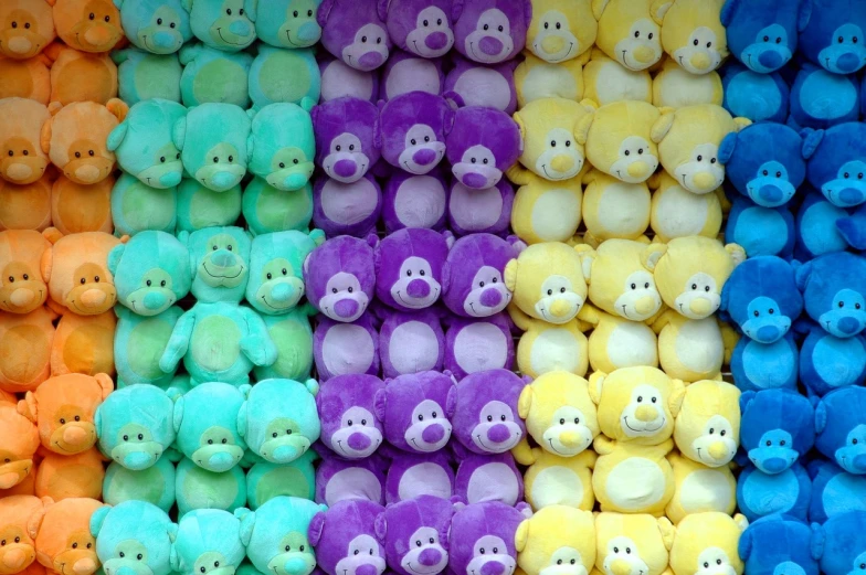 a close up of a bunch of stuffed animals, a picture, flickr, color field, yellow purple green, monkey, slides, repetition